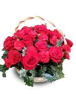 Flower arrangement of roses and carnations in a basket